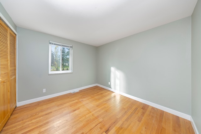 unfurnished bedroom featuring a closet and light hardwood / wood-style floors