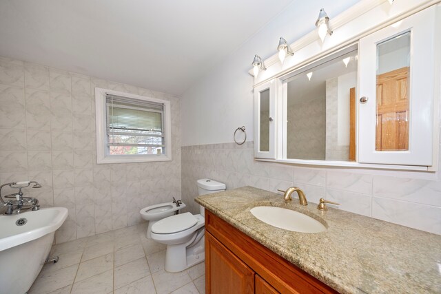 5731 Farmington Rd, West Bloomfield, MI 48322 - full bathroom with a freestanding bath, tile walls, vanity, toilet, and a bidet