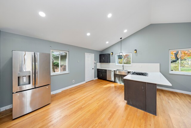 5731 Farmington Rd, West Bloomfield, MI 48322 - kitchen featuring stainless steel appliances, a peninsula, light countertops, a sink, and light wood-style floors