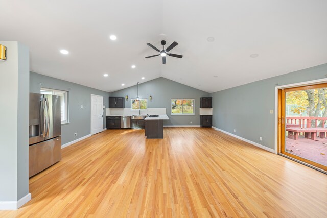 5731 Farmington Rd, West Bloomfield, MI 48322 - unfurnished living room featuring light wood finished floors, vaulted ceiling, a ceiling fan, baseboards, and recessed lighting