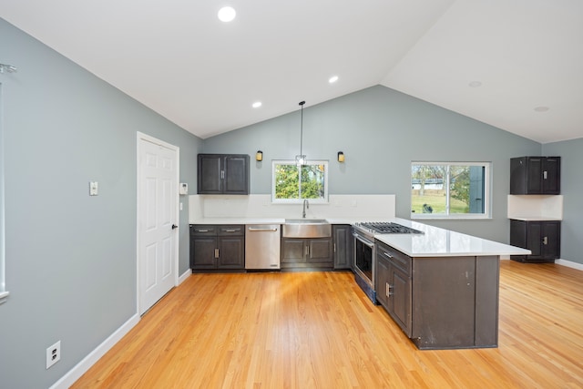 kitchen with pendant lighting, vaulted ceiling, light hardwood / wood-style flooring, kitchen peninsula, and stainless steel appliances