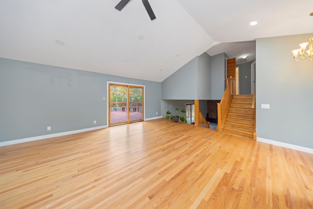 unfurnished living room featuring ceiling fan with notable chandelier, light hardwood / wood-style floors, and lofted ceiling