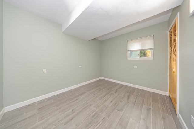 spare room with light wood-type flooring