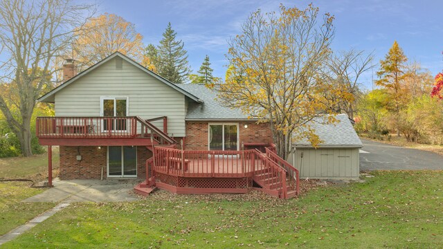 5731 Farmington Rd, West Bloomfield, MI 48322 - back of property featuring a patio area, a wooden deck, brick siding, and a lawn