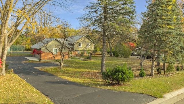 5731 Farmington Rd, West Bloomfield, MI 48322 - view of front of home featuring a front yard, brick siding, driveway, and a garage