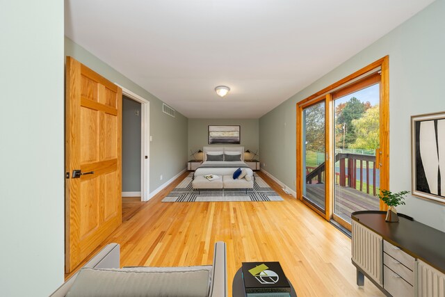 5731 Farmington Rd, West Bloomfield, MI 48322 - bedroom featuring access to exterior, wood finished floors, and baseboards
