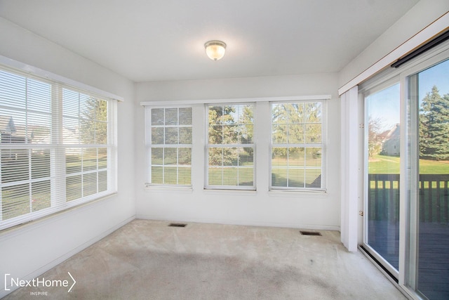 unfurnished sunroom featuring a wealth of natural light