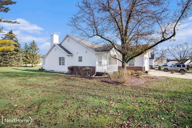 view of side of home with a yard