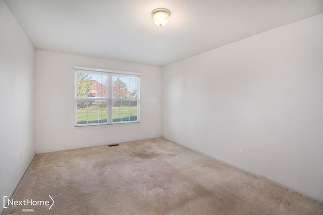 empty room featuring light carpet