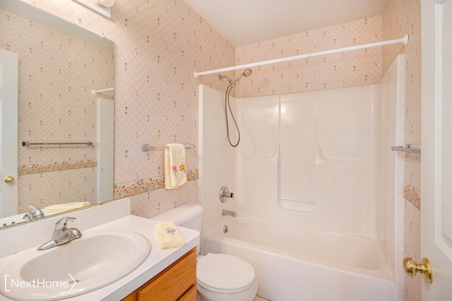 full bathroom featuring shower / bathing tub combination, vanity, and toilet