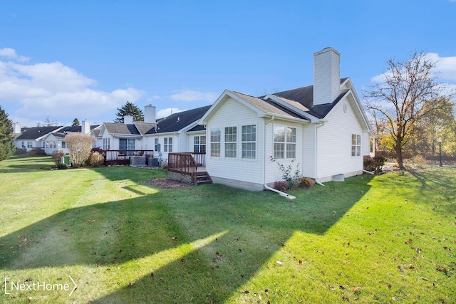 back of house featuring a yard and a deck