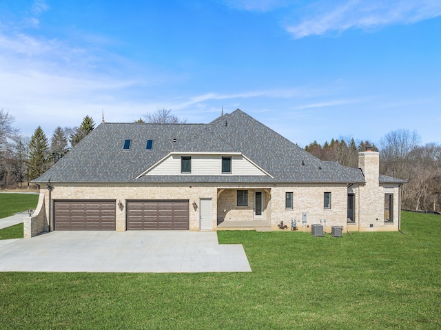 view of front of house with cooling unit, a garage, and a front lawn