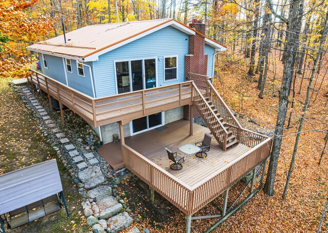 rear view of house featuring a deck