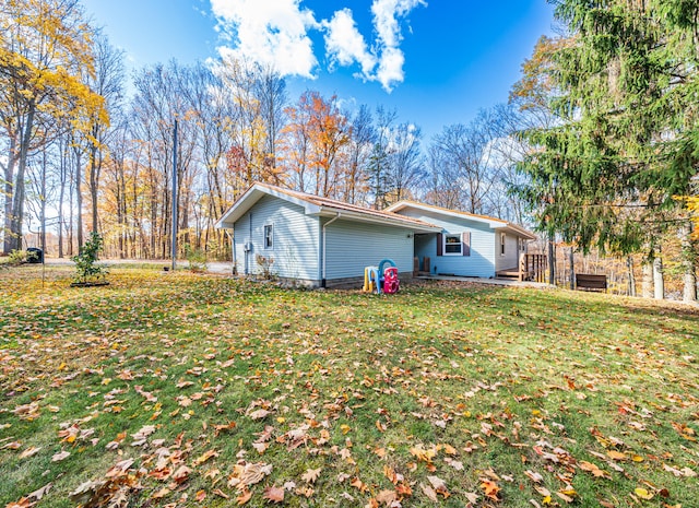 rear view of property featuring a yard