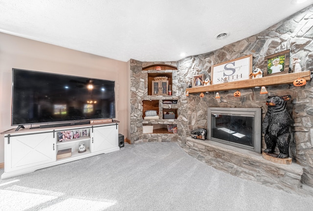 living room with carpet, a textured ceiling, and a fireplace