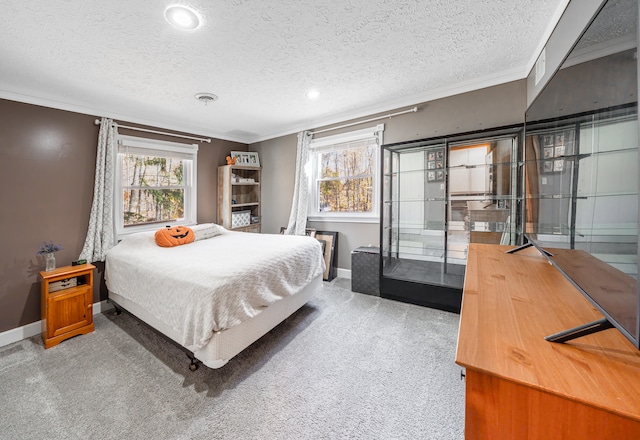 bedroom featuring a textured ceiling, carpet floors, and ornamental molding