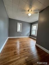 interior space featuring a wealth of natural light, ceiling fan, and dark hardwood / wood-style floors