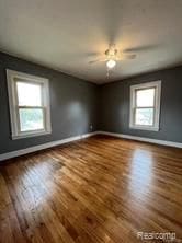 additional living space with hardwood / wood-style floors, ceiling fan, and a healthy amount of sunlight