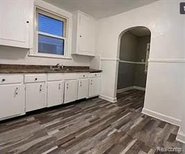 kitchen featuring dark hardwood / wood-style floors and white cabinetry