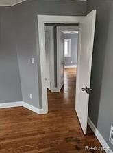 hall with dark hardwood / wood-style floors