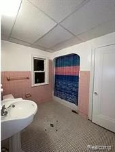 bathroom with a drop ceiling