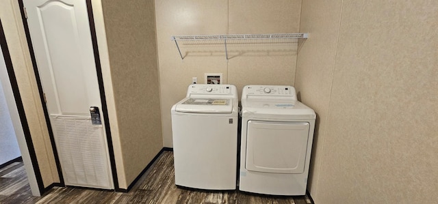 laundry room featuring dark hardwood / wood-style floors and washing machine and clothes dryer