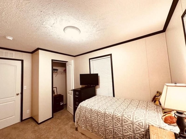 bedroom with a closet, light colored carpet, a textured ceiling, and ornamental molding