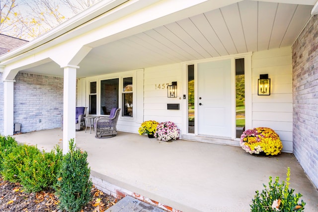 property entrance with covered porch