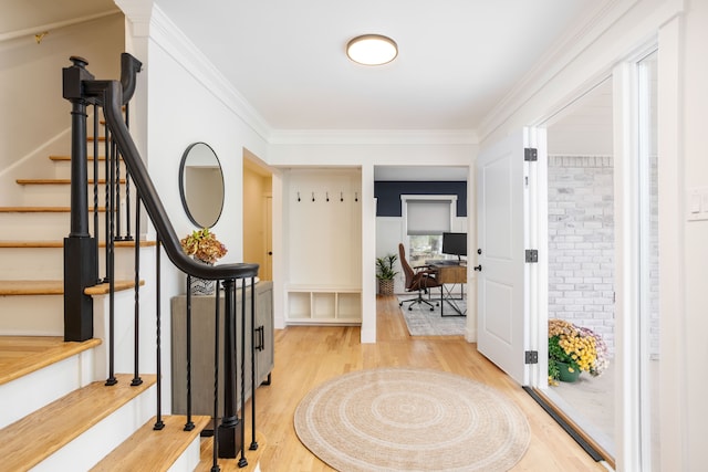 entrance foyer with light hardwood / wood-style flooring and ornamental molding