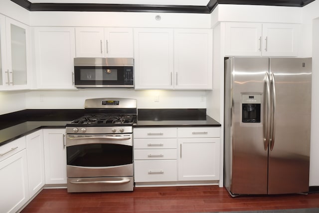 kitchen featuring white cabinets, appliances with stainless steel finishes, and dark hardwood / wood-style floors