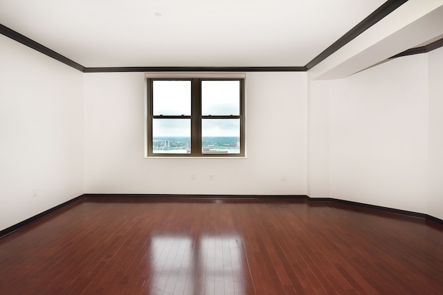 unfurnished room with crown molding and dark wood-type flooring