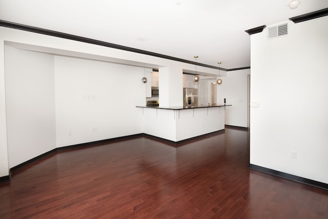 unfurnished living room with crown molding and dark wood-type flooring