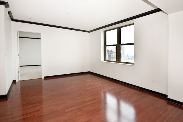 unfurnished room featuring crown molding and dark hardwood / wood-style flooring