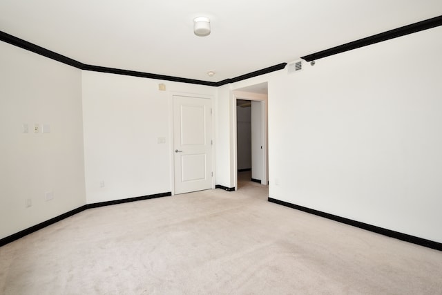 carpeted spare room with crown molding