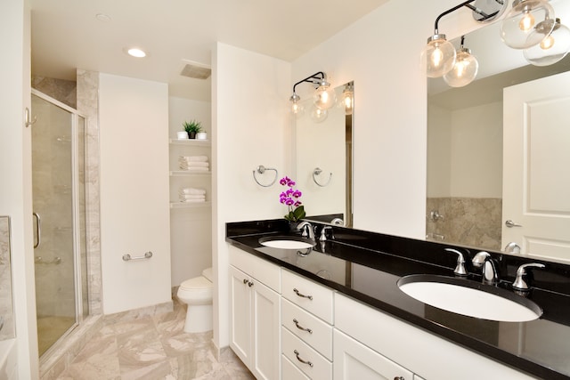 bathroom featuring vanity, toilet, and walk in shower