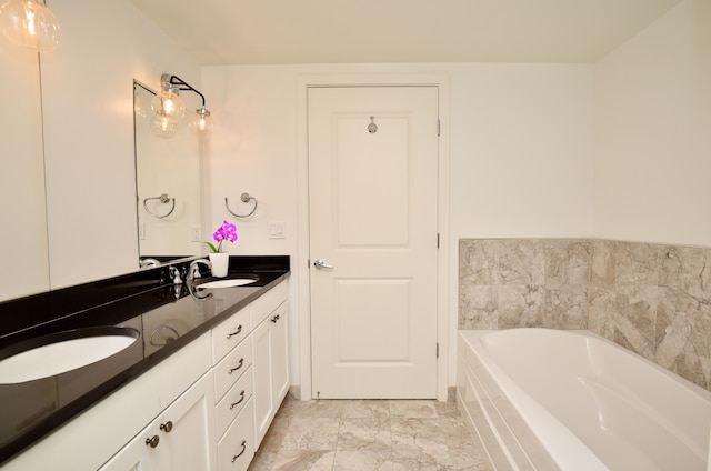 bathroom with vanity and a tub