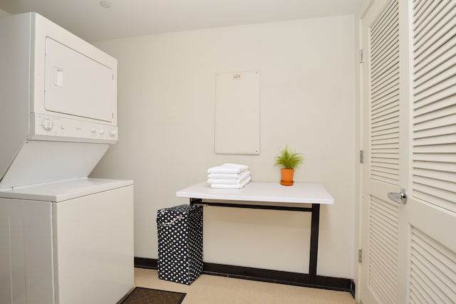 clothes washing area featuring stacked washer and dryer