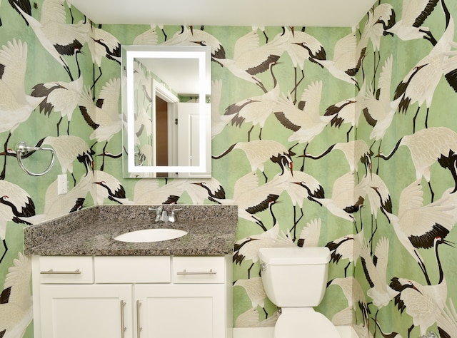 bathroom featuring vanity and toilet