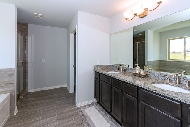 bathroom with vanity and independent shower and bath