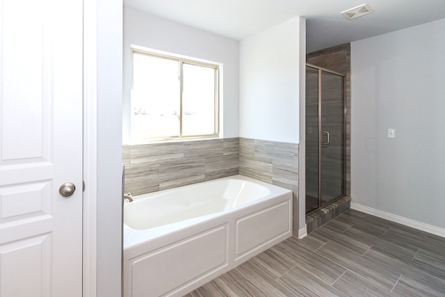 bathroom featuring separate shower and tub