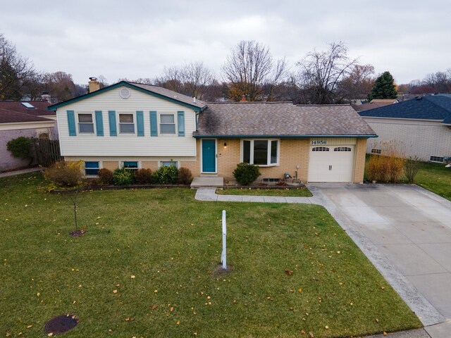 tri-level home with a front lawn and a garage