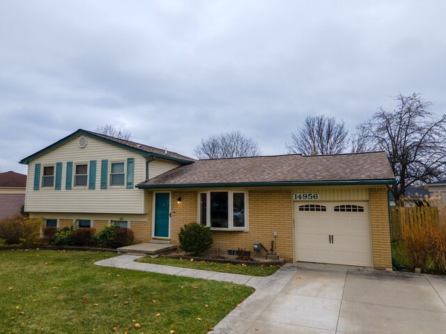 split level home with a front lawn and a garage