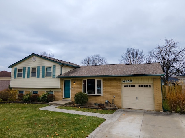 split level home with a garage and a front lawn