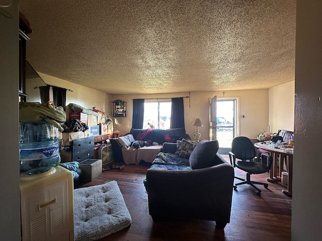 living room with dark wood-type flooring and a textured ceiling