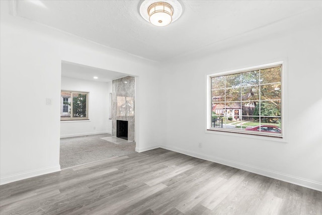 unfurnished living room featuring hardwood / wood-style flooring and a fireplace