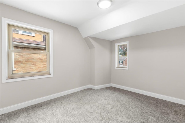 bonus room featuring carpet floors and lofted ceiling