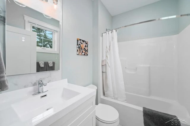 full bathroom with vanity, shower / bath combo, and toilet