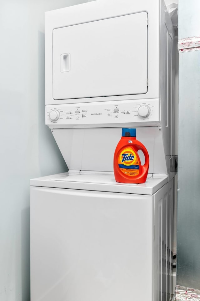 washroom featuring stacked washer / dryer