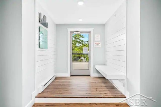 mudroom with hardwood / wood-style floors and a baseboard heating unit