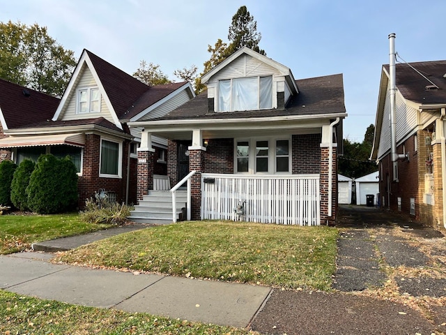 view of front facade with covered porch and a front lawn